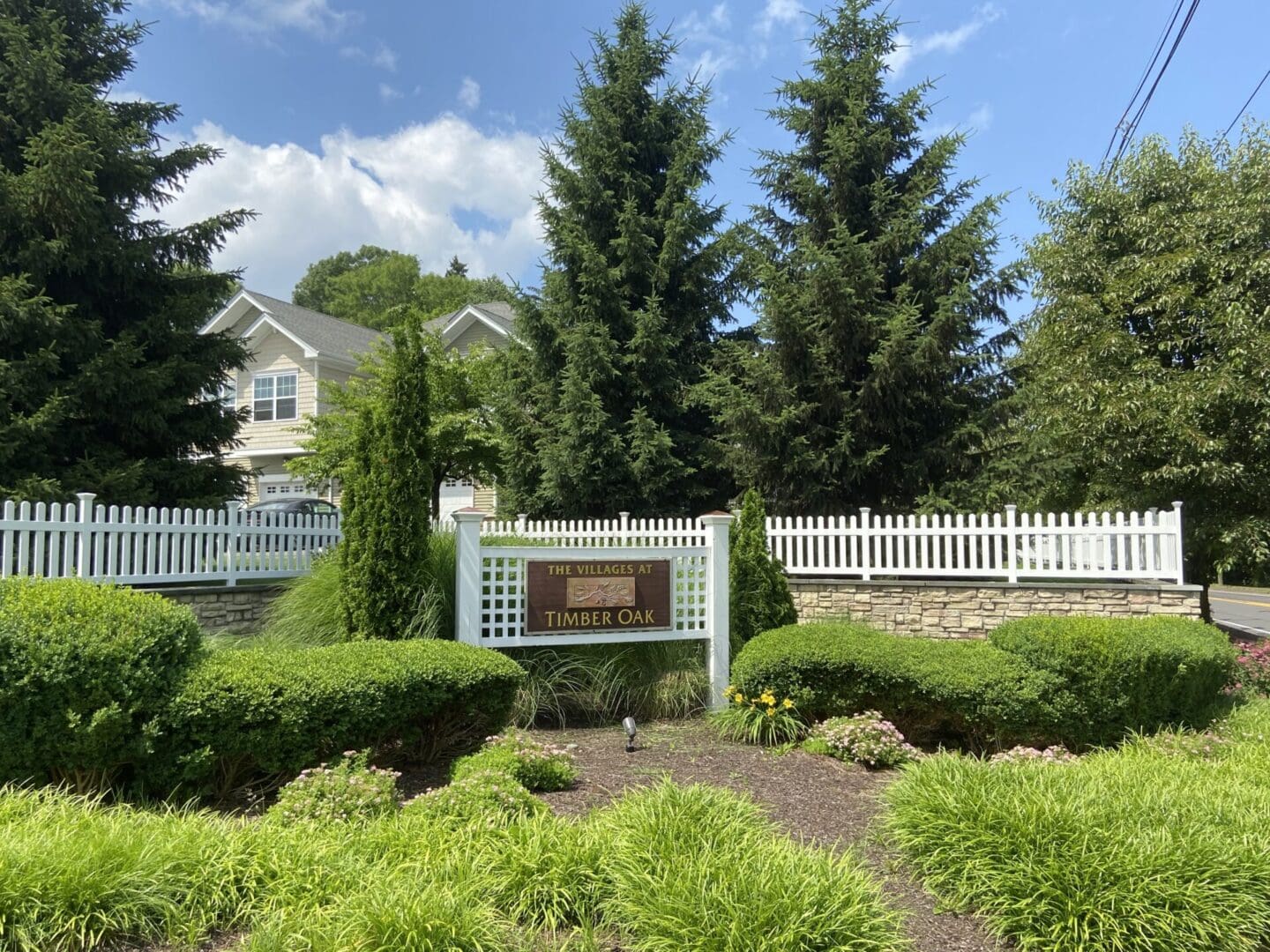 A sign in the middle of a garden area.