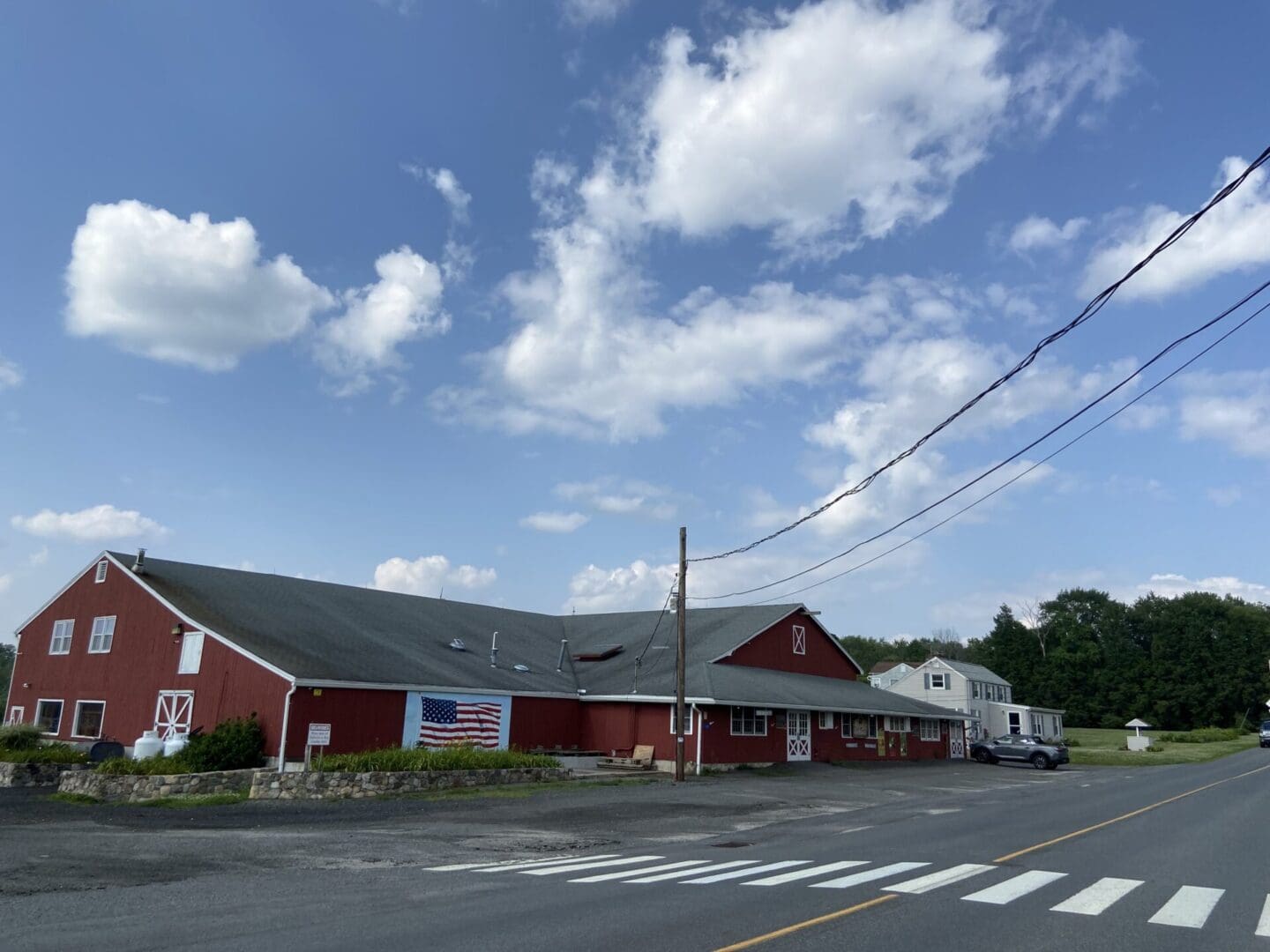 A red building with a white roof on the side of it.