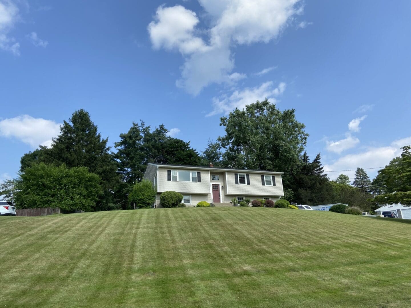 A house with a large yard in the background