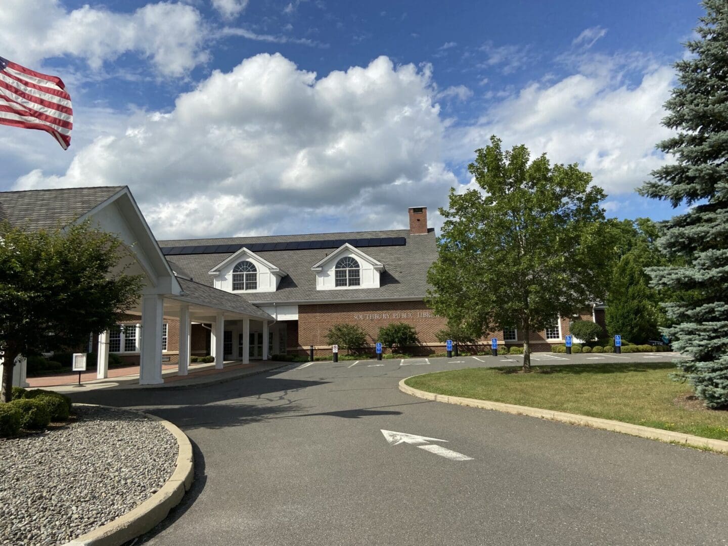 The entrance to a nursing home with an american flag.