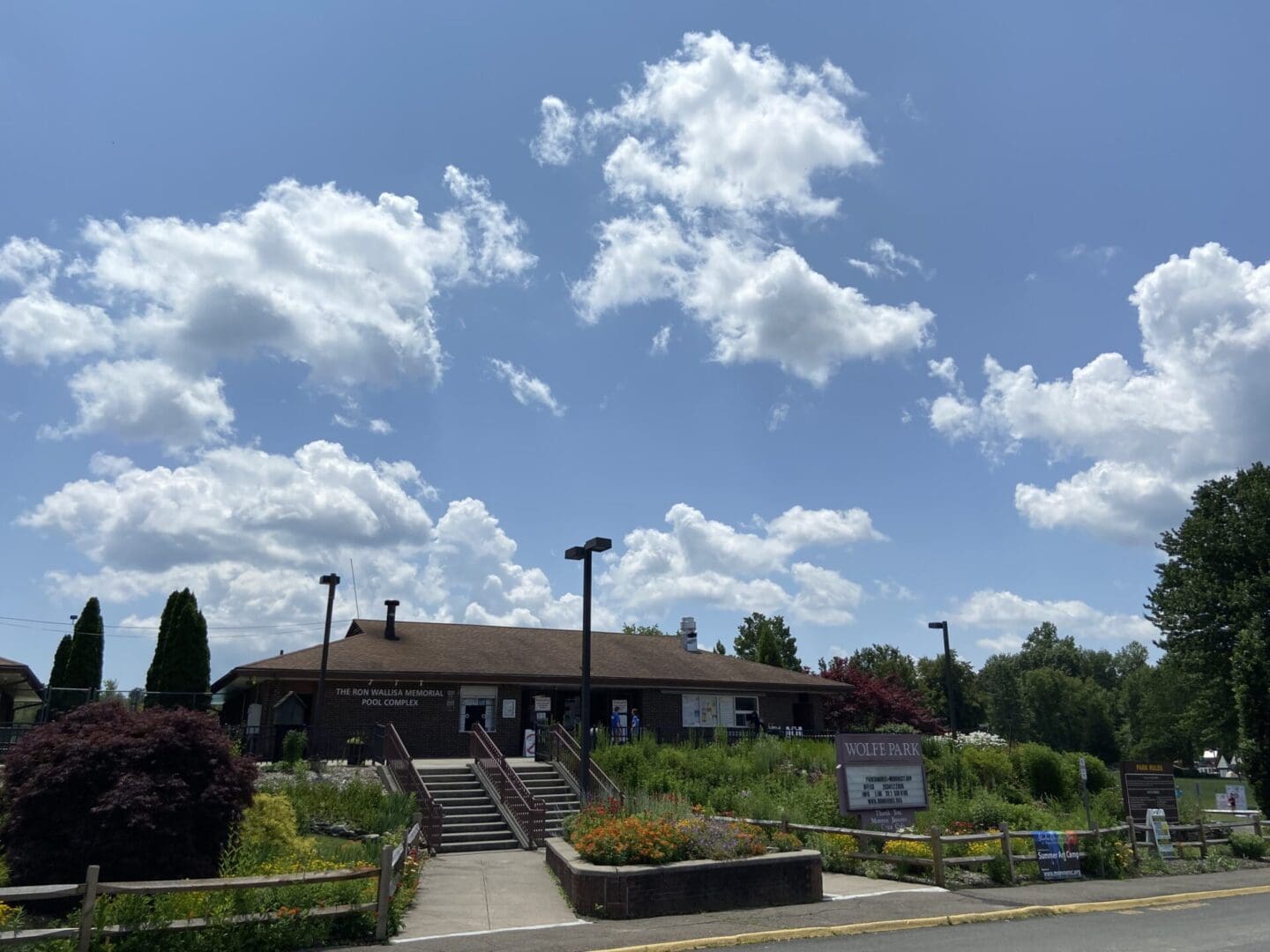 A building with a grassy area and a cloudy sky.