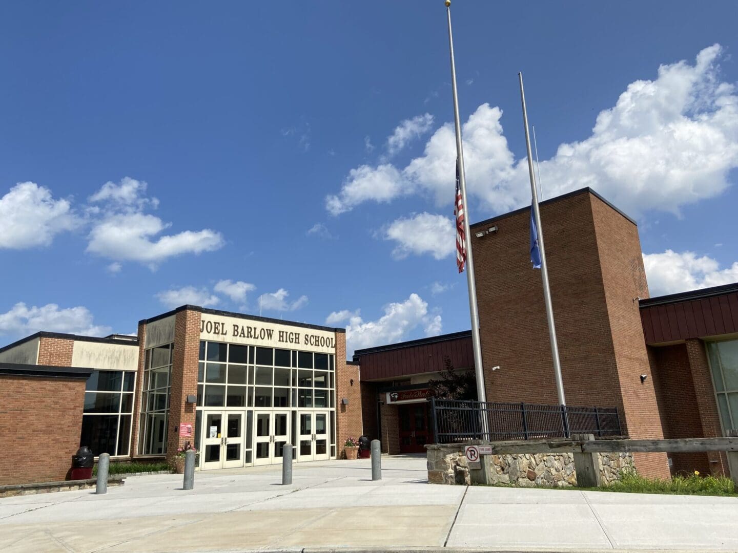 A building with two flags in front of it.