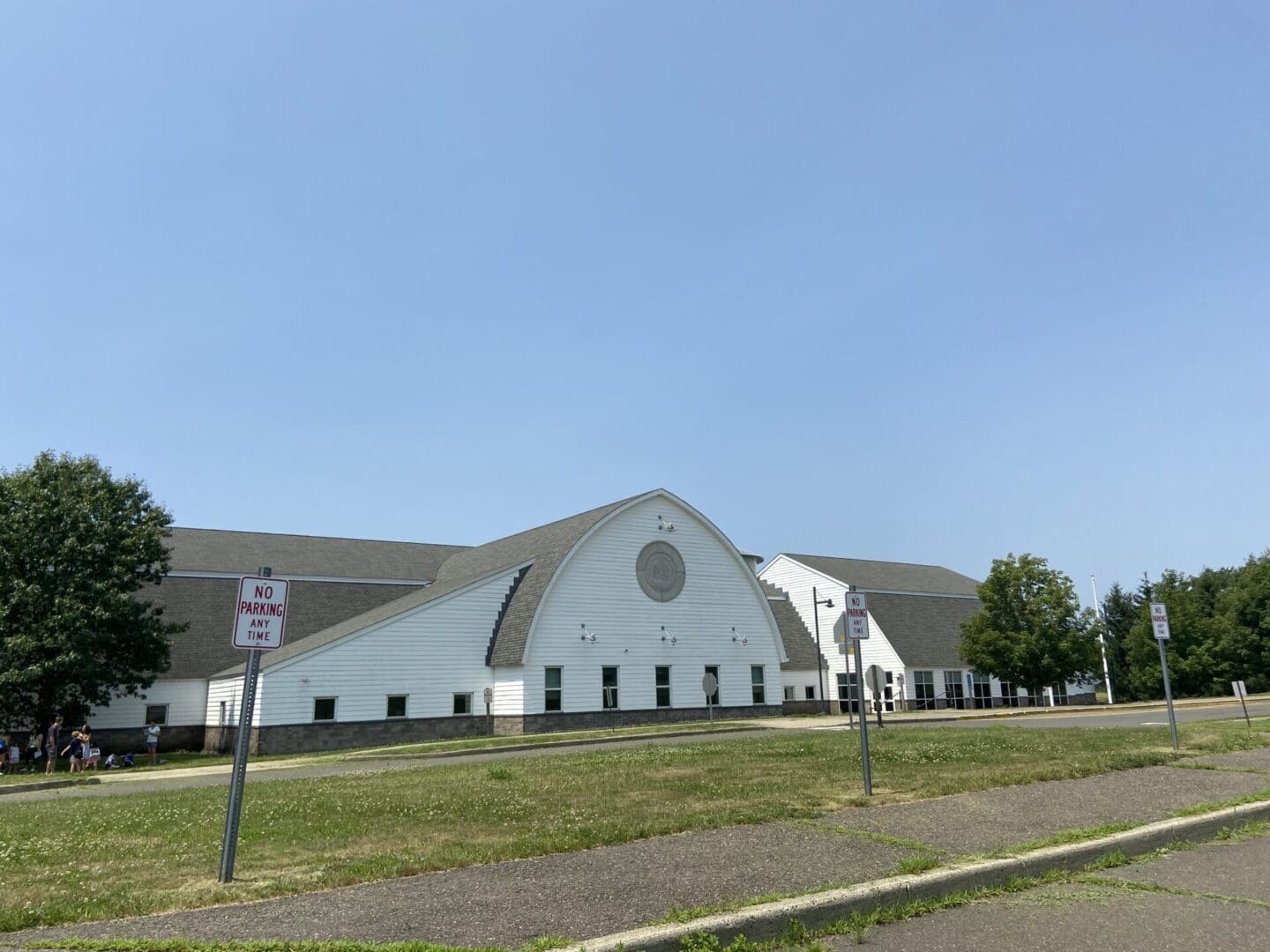 A large white building with a circular window.