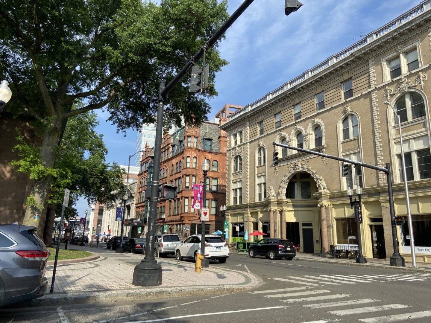 A street with cars parked on the side of it.