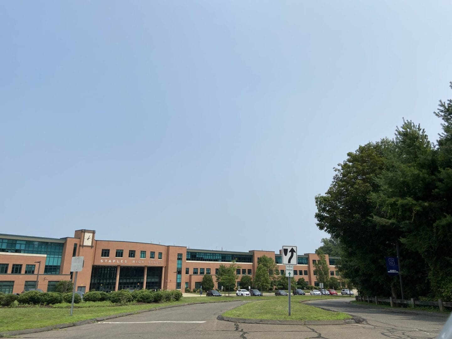 An office building with a parking lot in front of it.