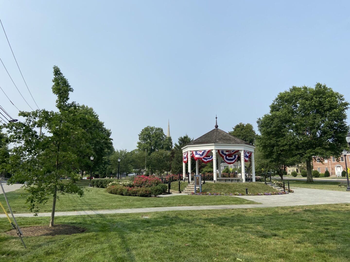 A gazebo sits in the middle of a park.