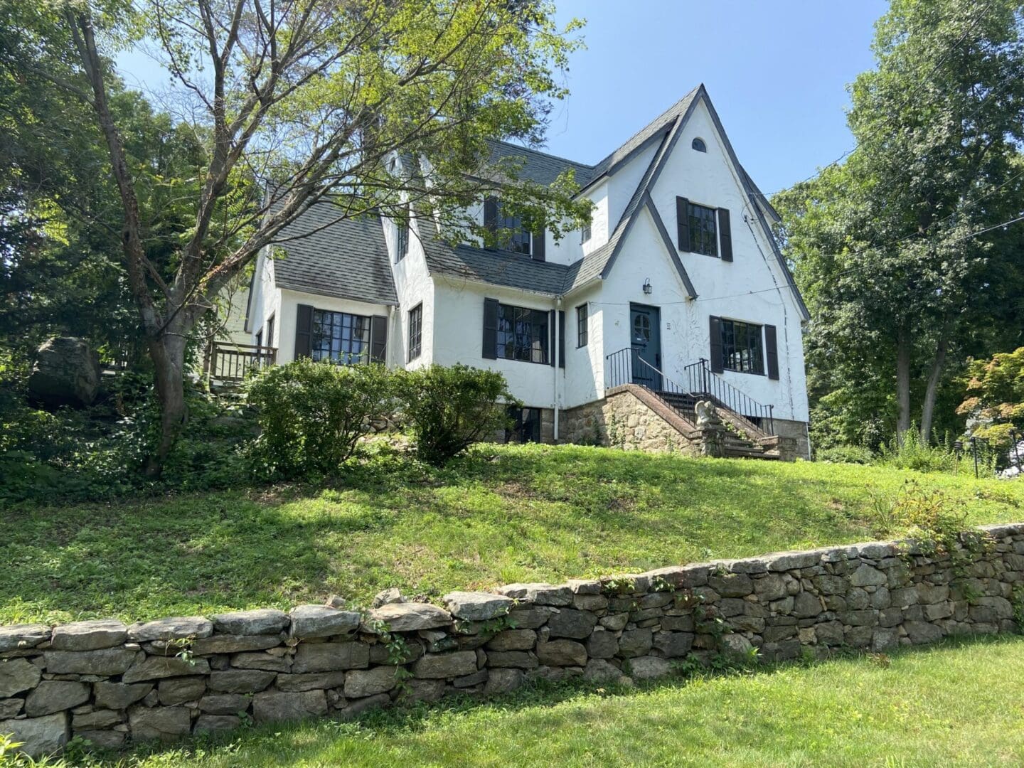 A large white house sitting on top of a hill.