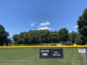 A baseball field with a sign on it