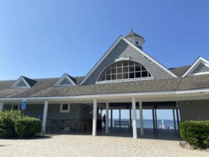 A large building with a porch and a view of the ocean.