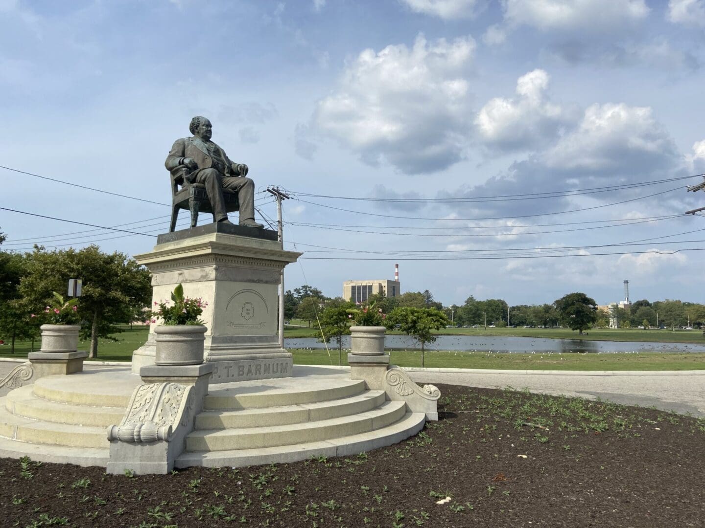 A statue of a man sitting on top of a chair.