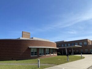 The front of a hospital building with a blue sky.