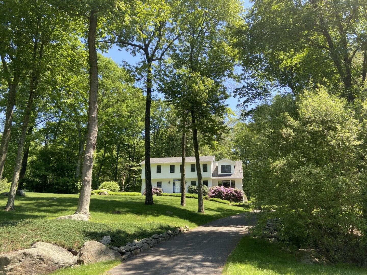 White house on a grassy driveway.