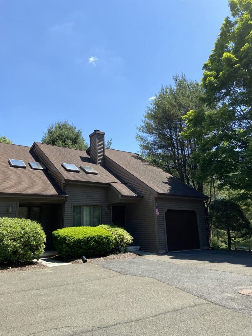 Brown house with garage and driveway.