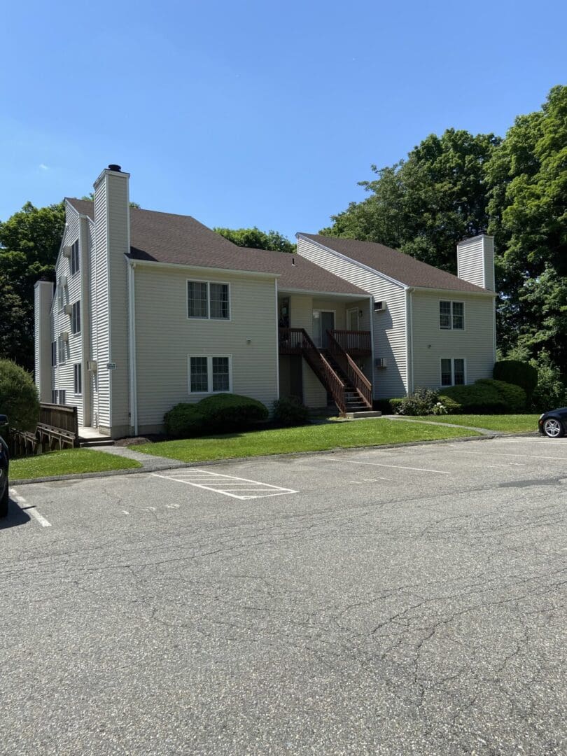 Two-story apartment building with parking lot.