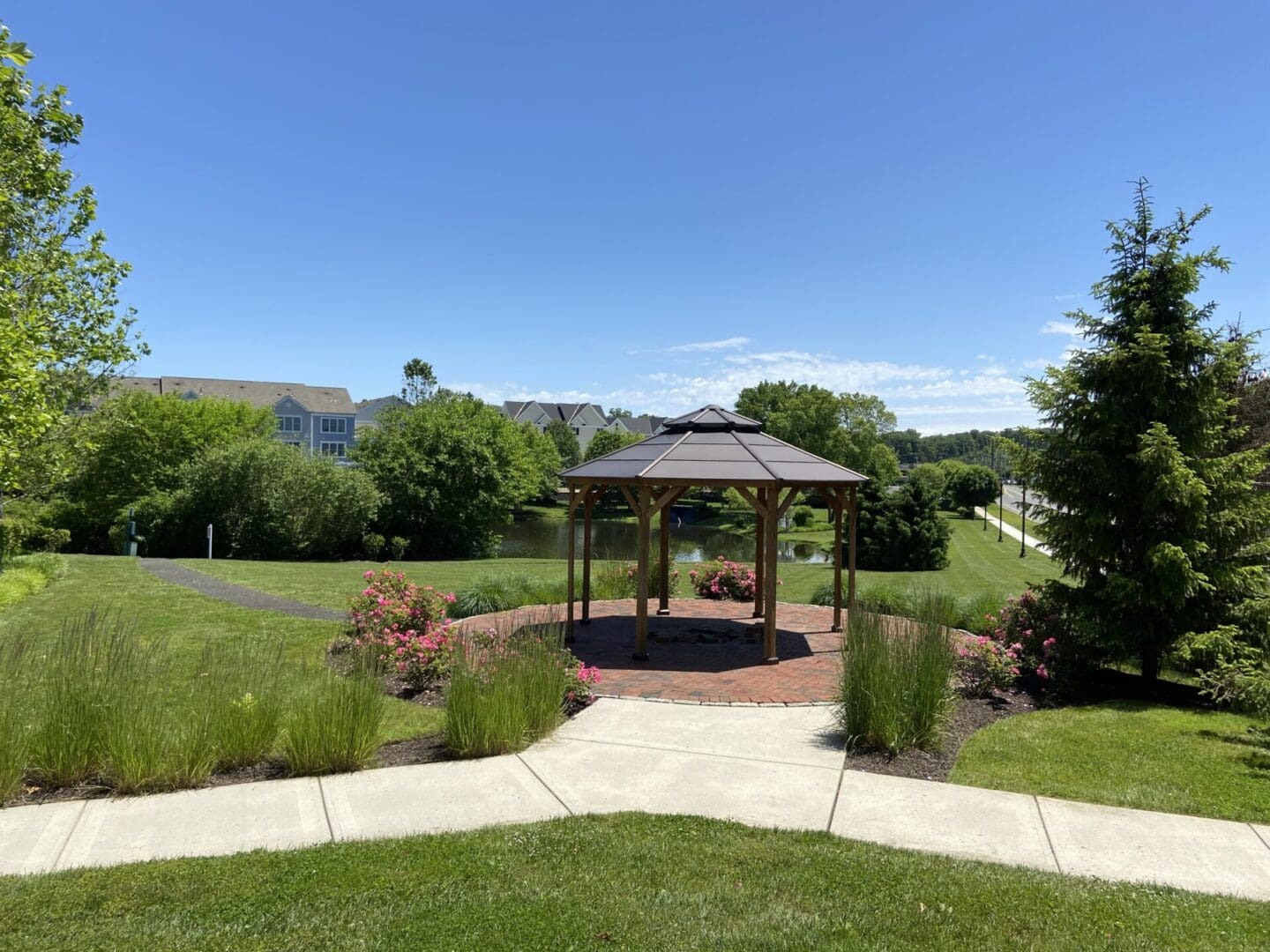 Gazebo with brick patio and pond.