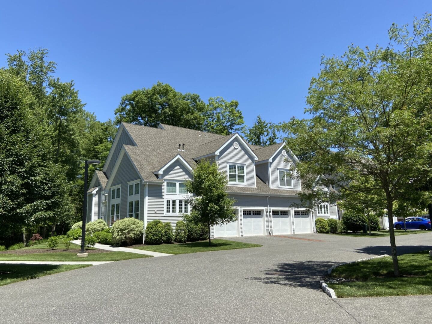 Gray house with three garage doors.