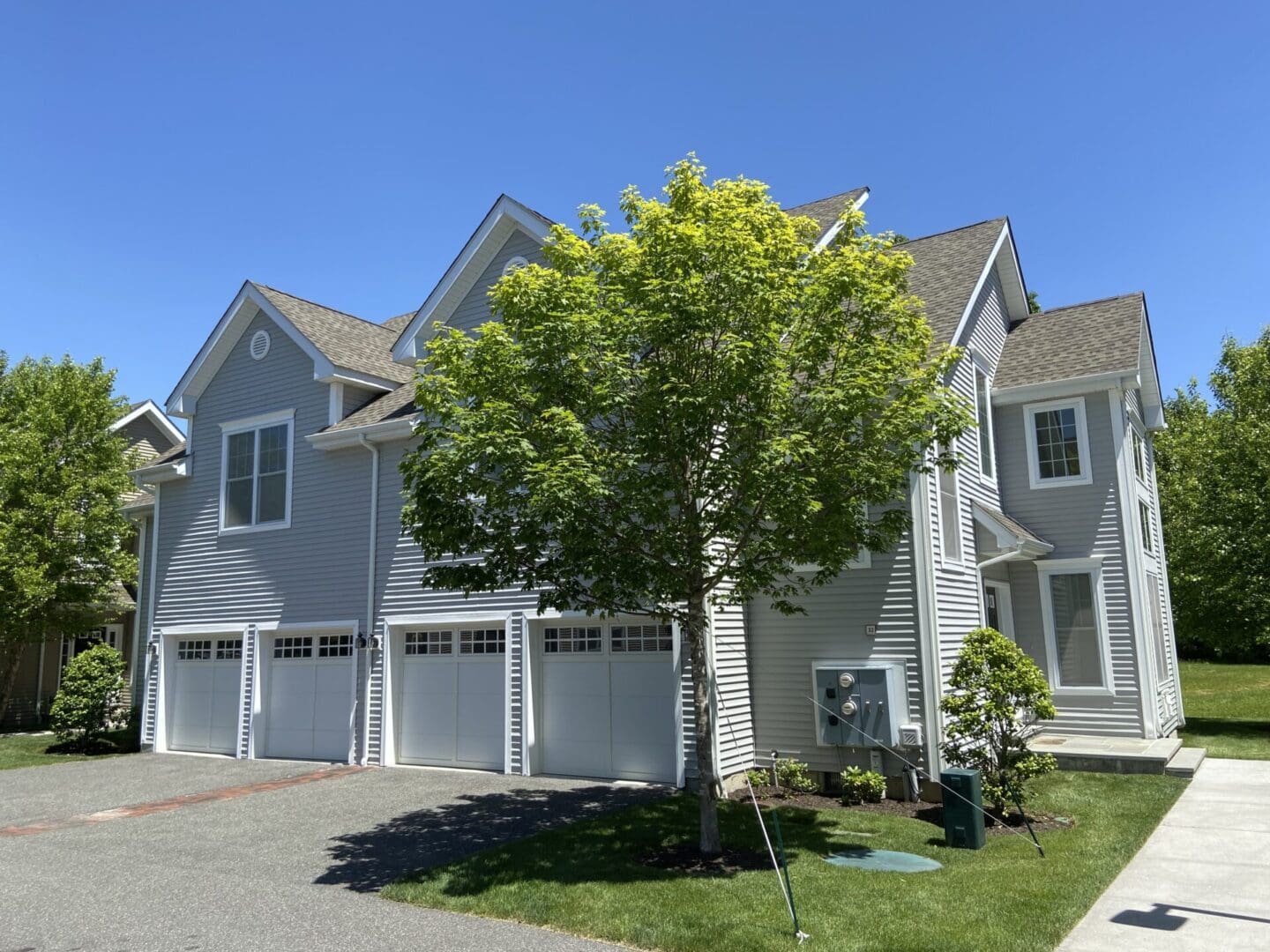 Gray house with three garage doors.