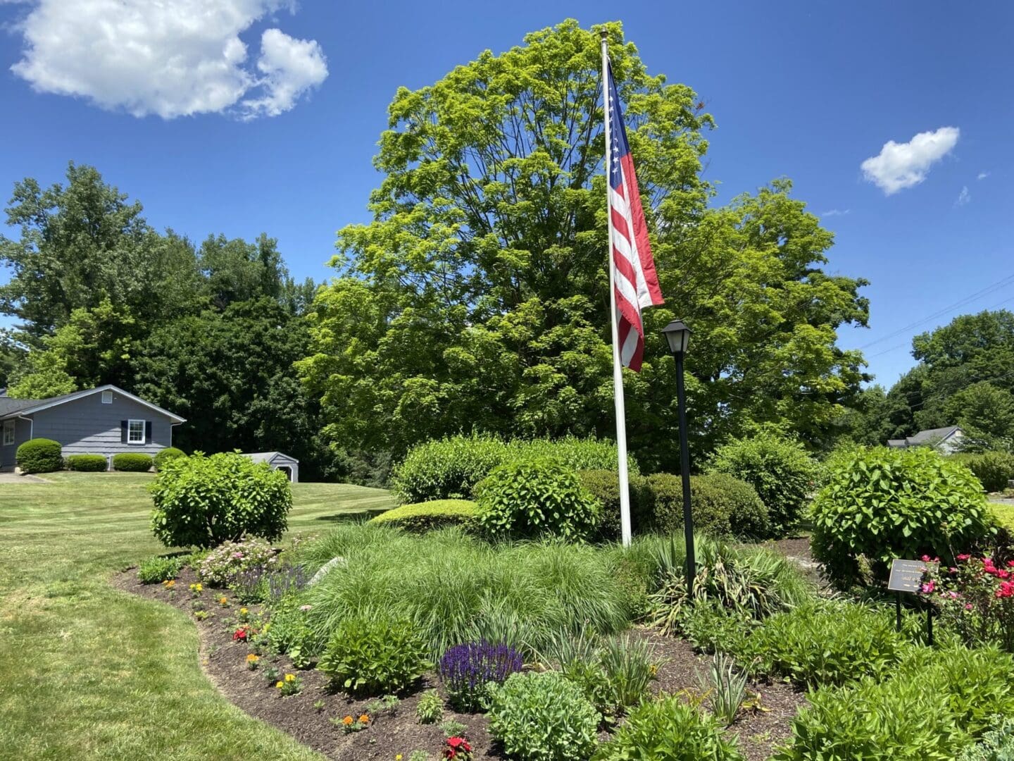 American flag waving in front of a house.