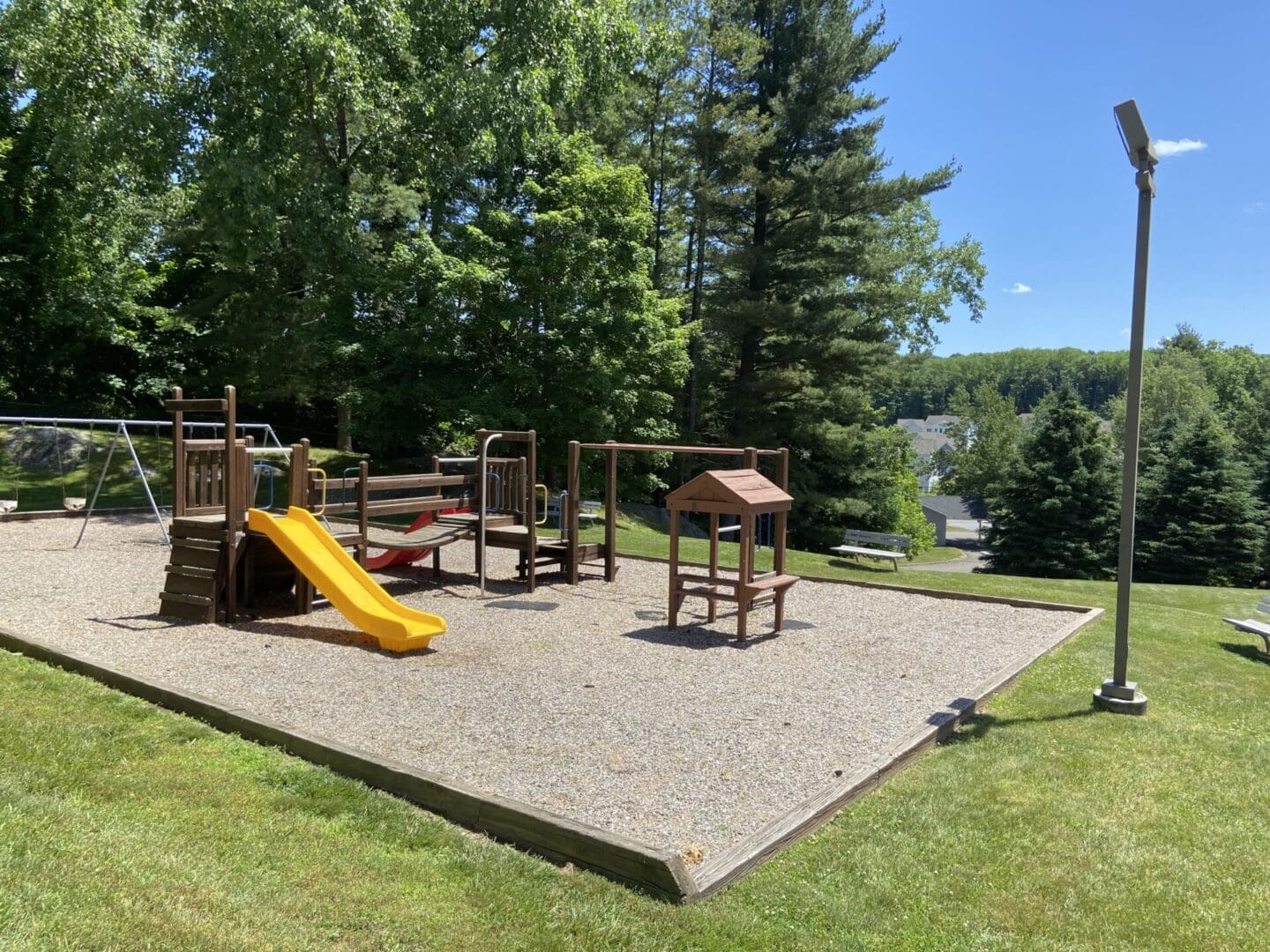 Children's playground with slide and swings.