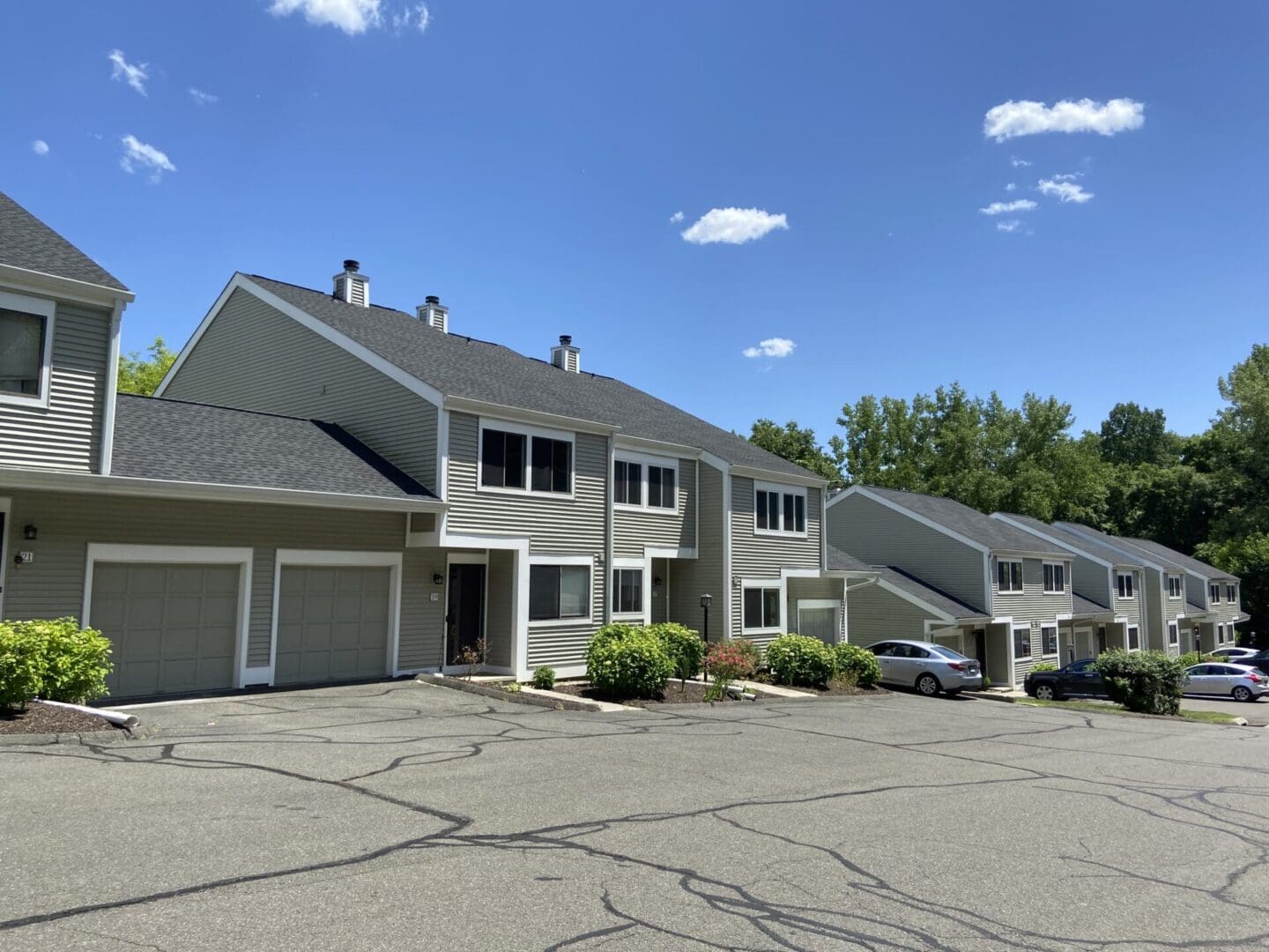 Row of gray houses with garages.