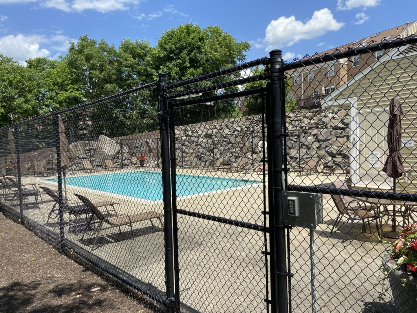 Fenced pool with keypad gate access.