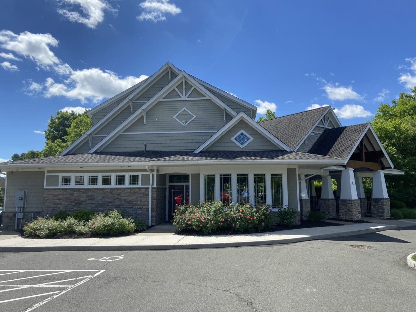 Gray building with stone accents and windows.