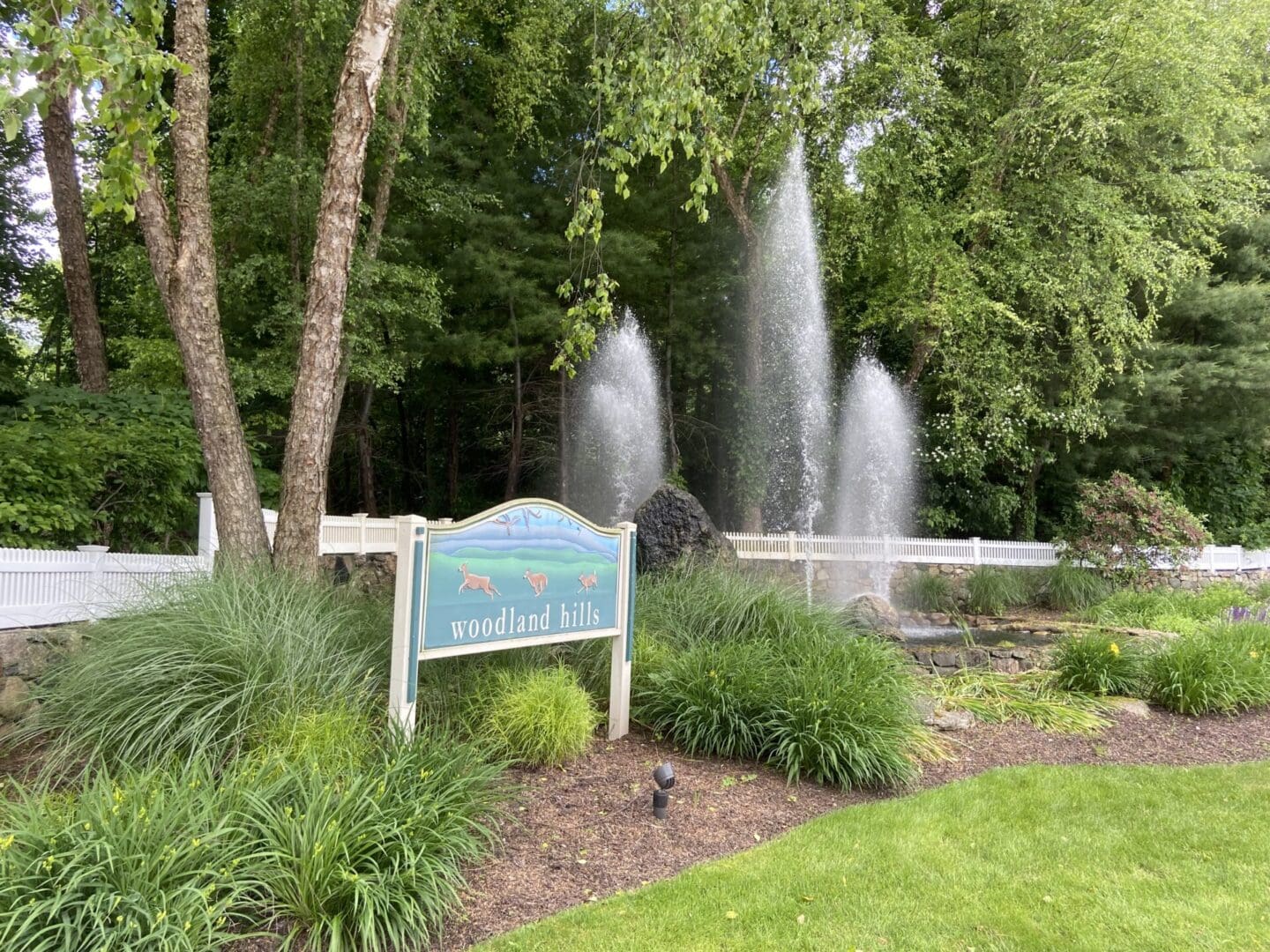 Woodland Hills sign with water fountain.