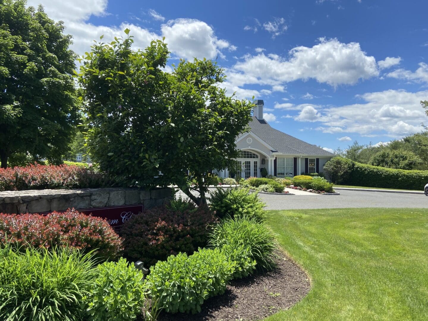 White building with landscaping and blue sky.