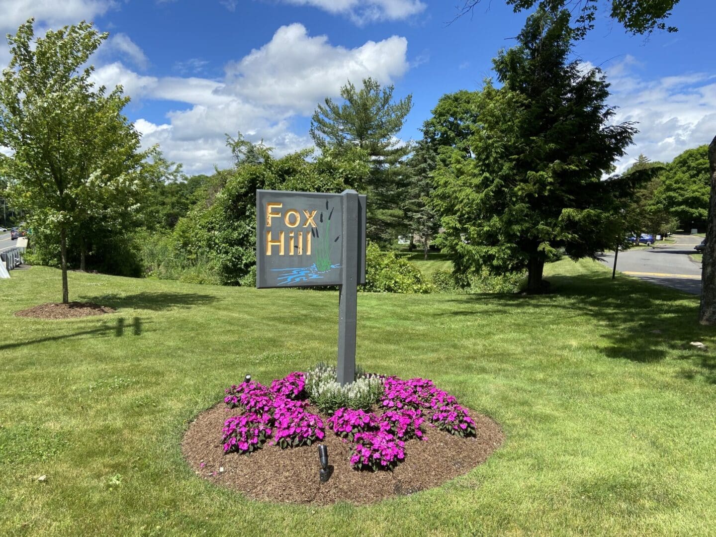 Fox Hill sign with pink flowers.