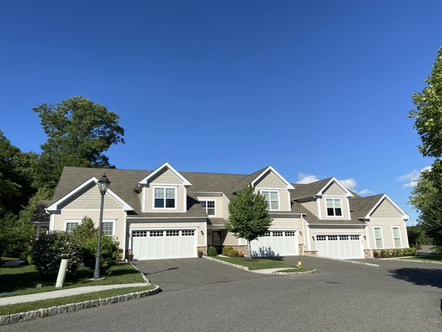 Beige townhouses with attached garages.