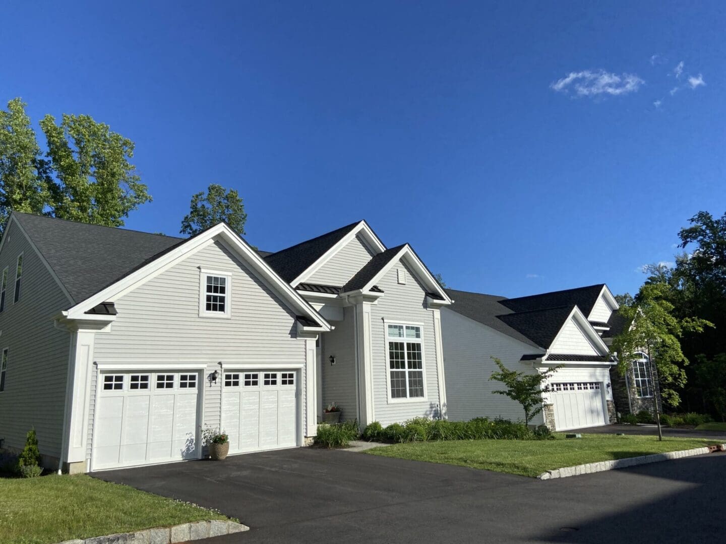 White suburban home with two-car garage.