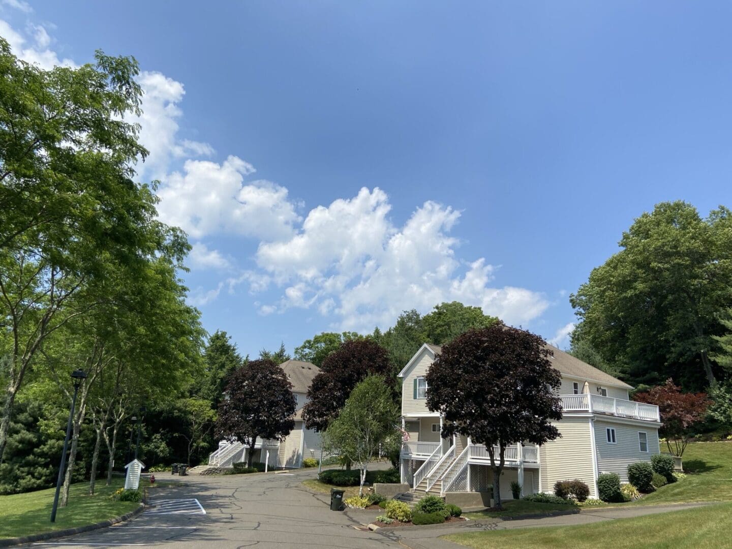 White townhouse with a green lawn.