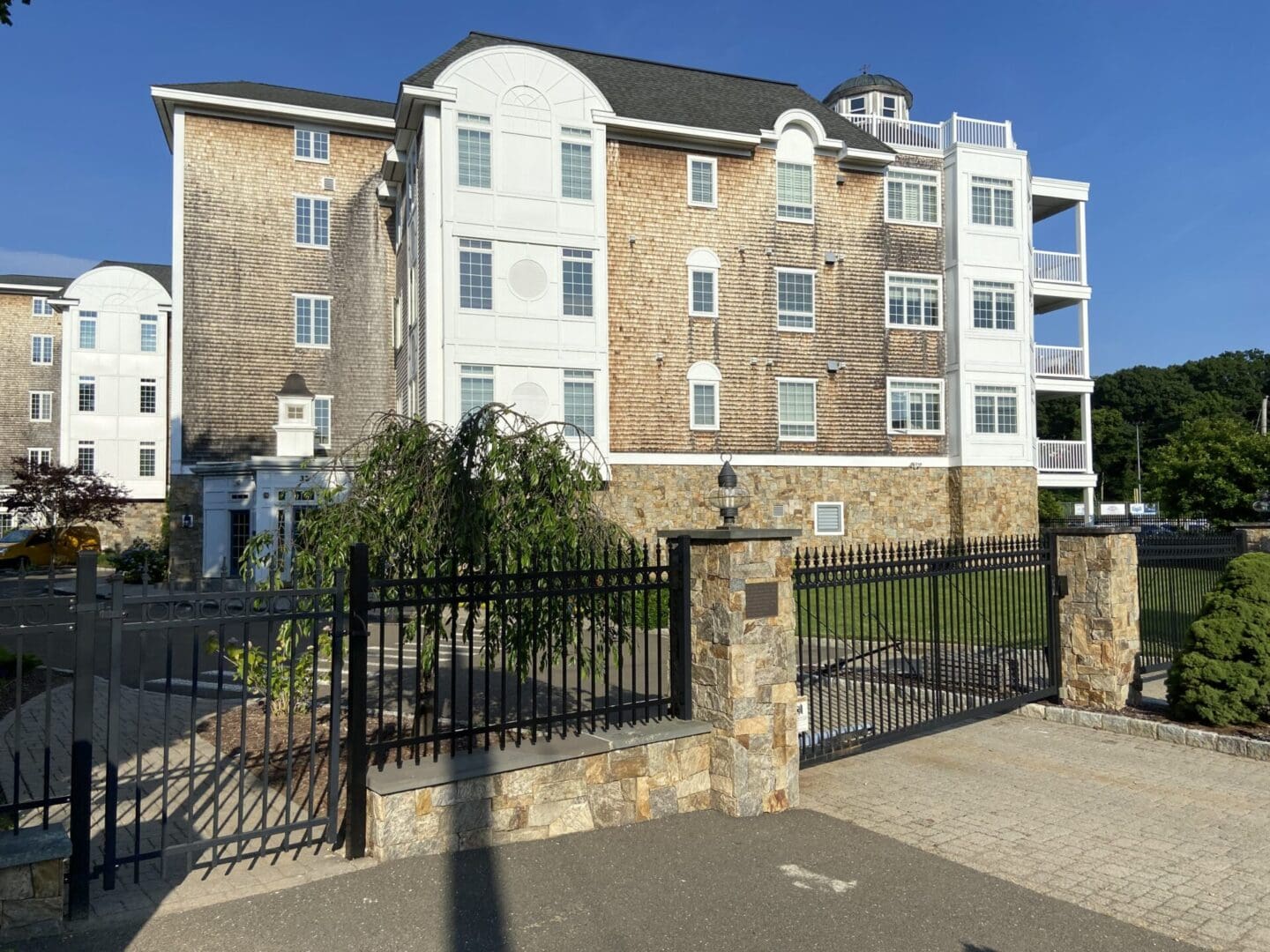 A gated entrance to a large apartment building.