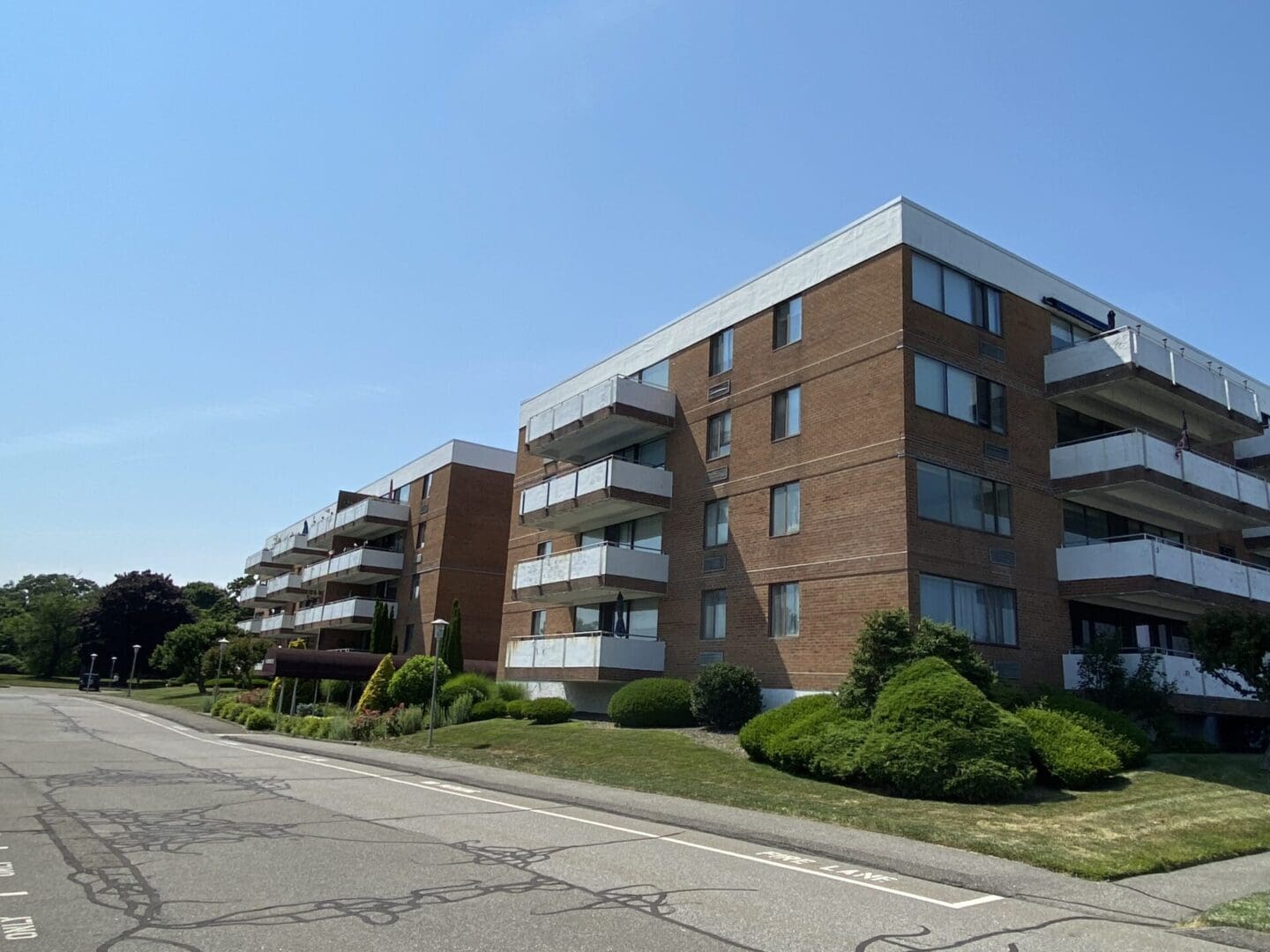 Brick apartment building with balconies.