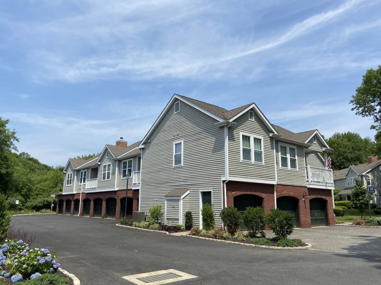 Gray house with garage doors and driveway.