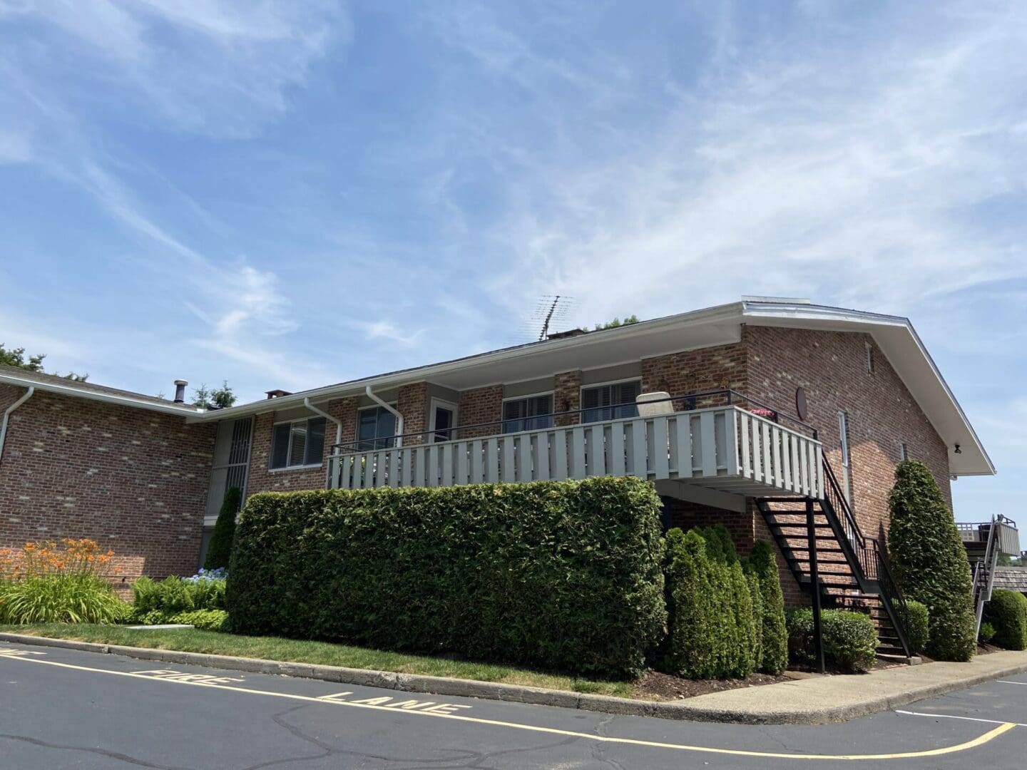 Brick building with balcony and stairs.