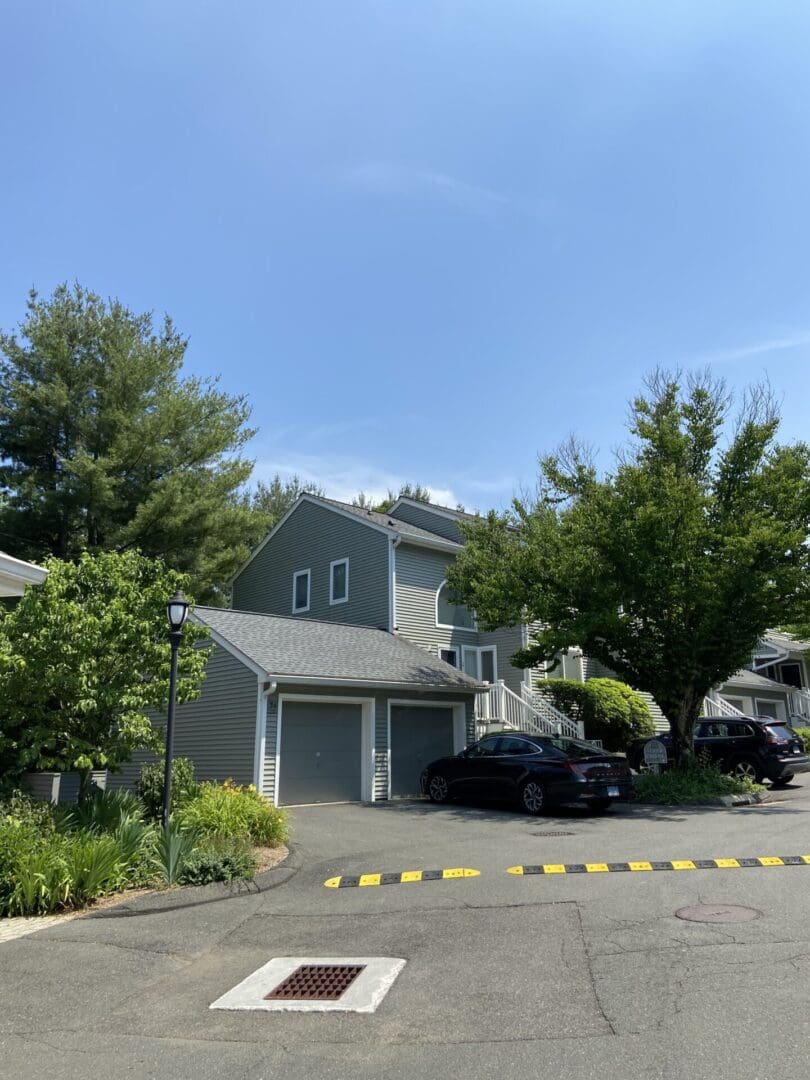 Two-story house with garage and car