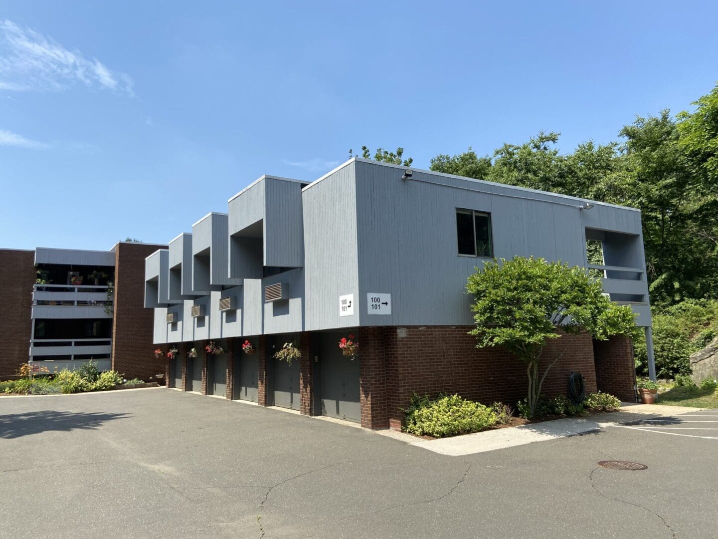 Gray building with multiple garages.