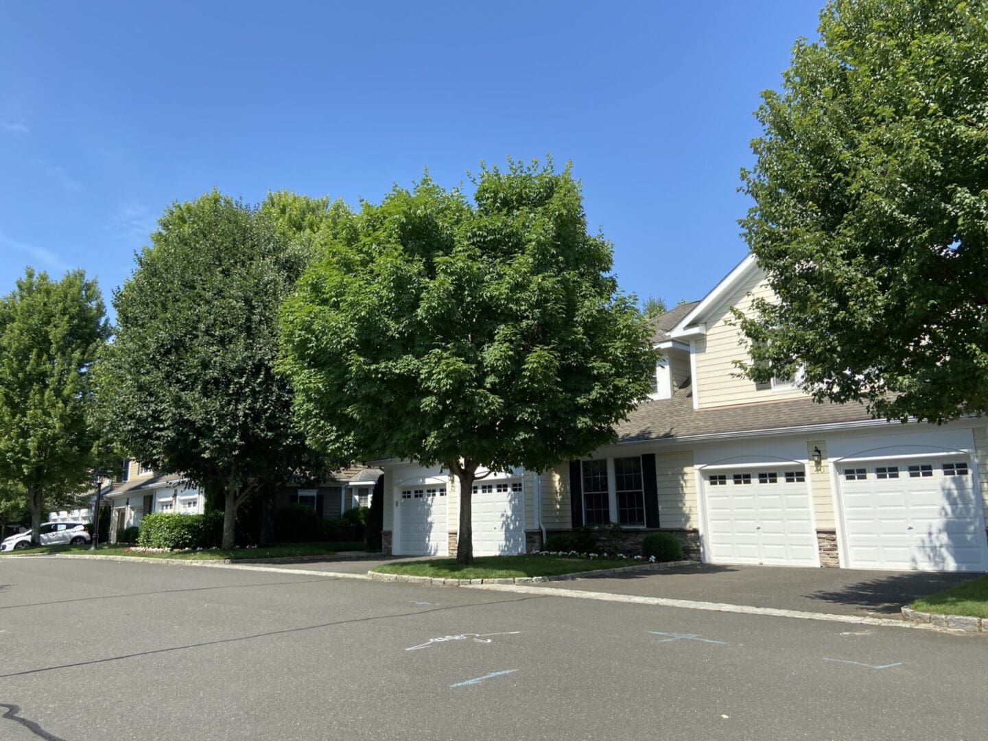 Townhouses with garages and landscaping.