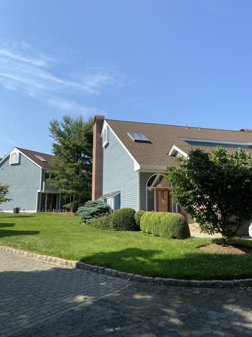 Blue house with a brick chimney.