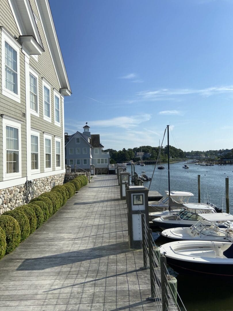 Wooden walkway leading to boats and harbor.