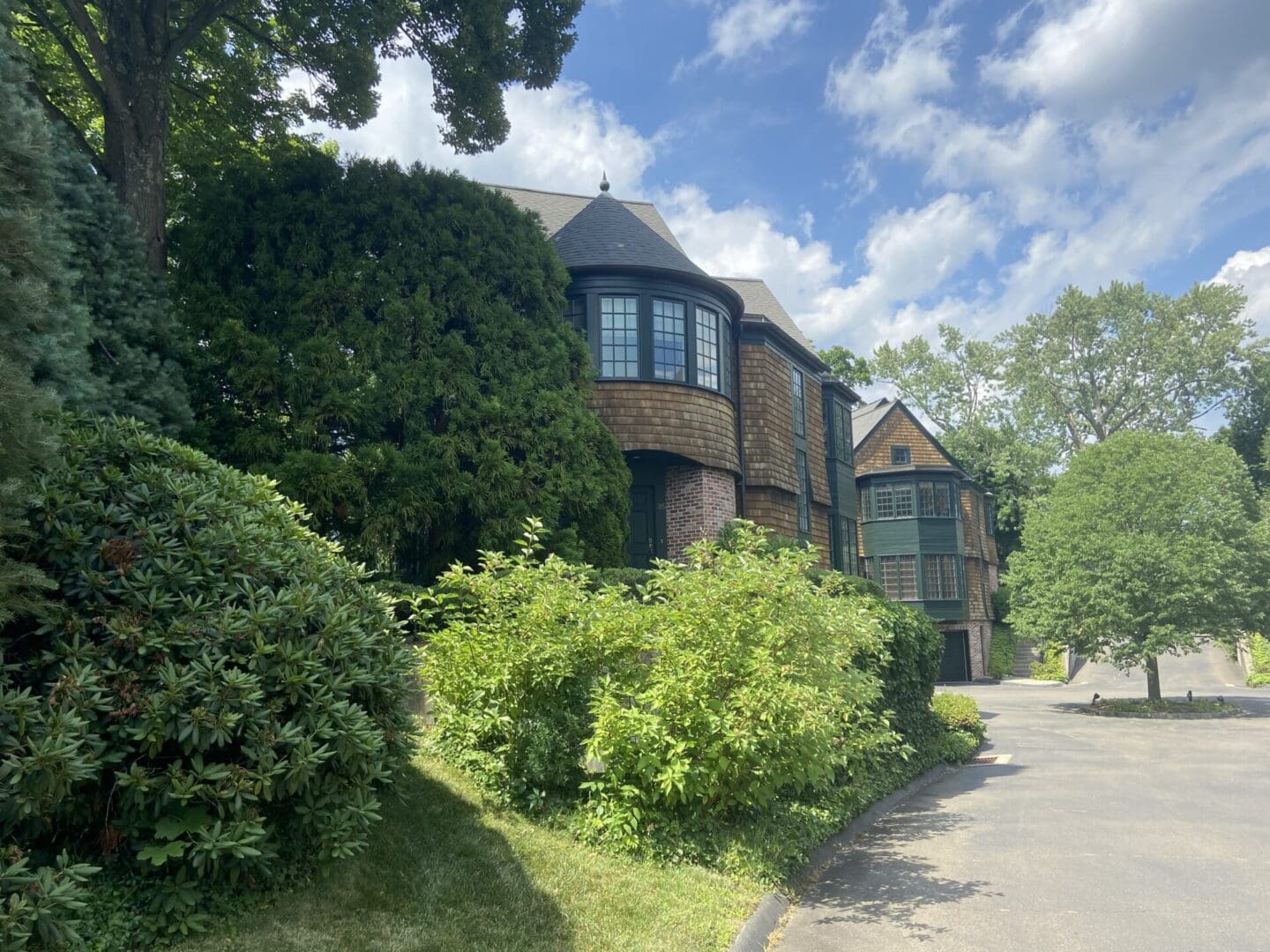 A green-trimmed house with a driveway.