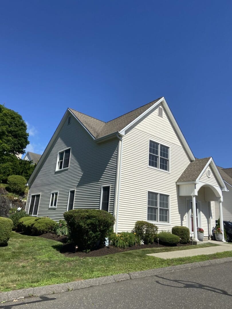 Suburban house under sunny blue sky.