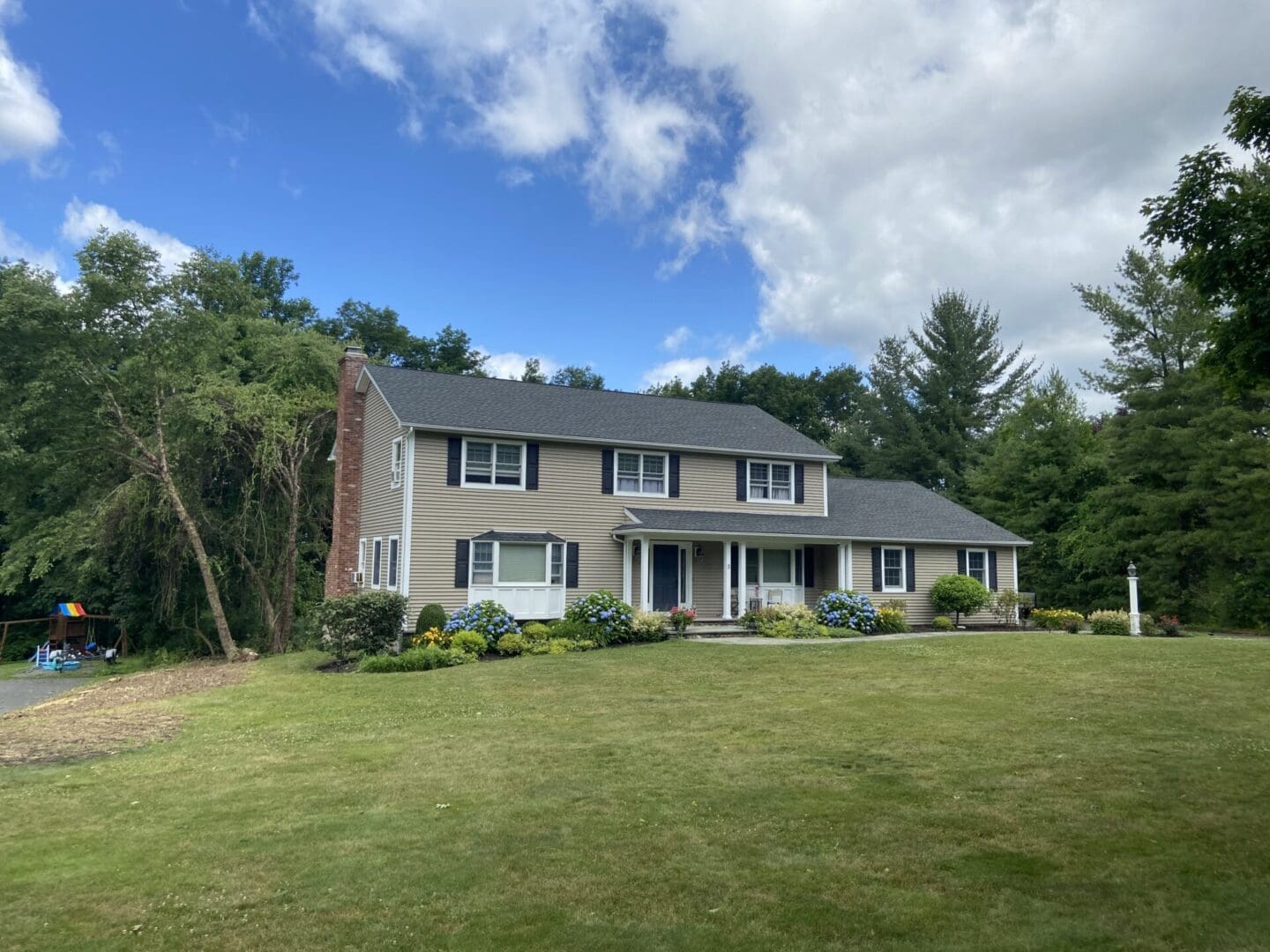 Two-story suburban house with lawn.