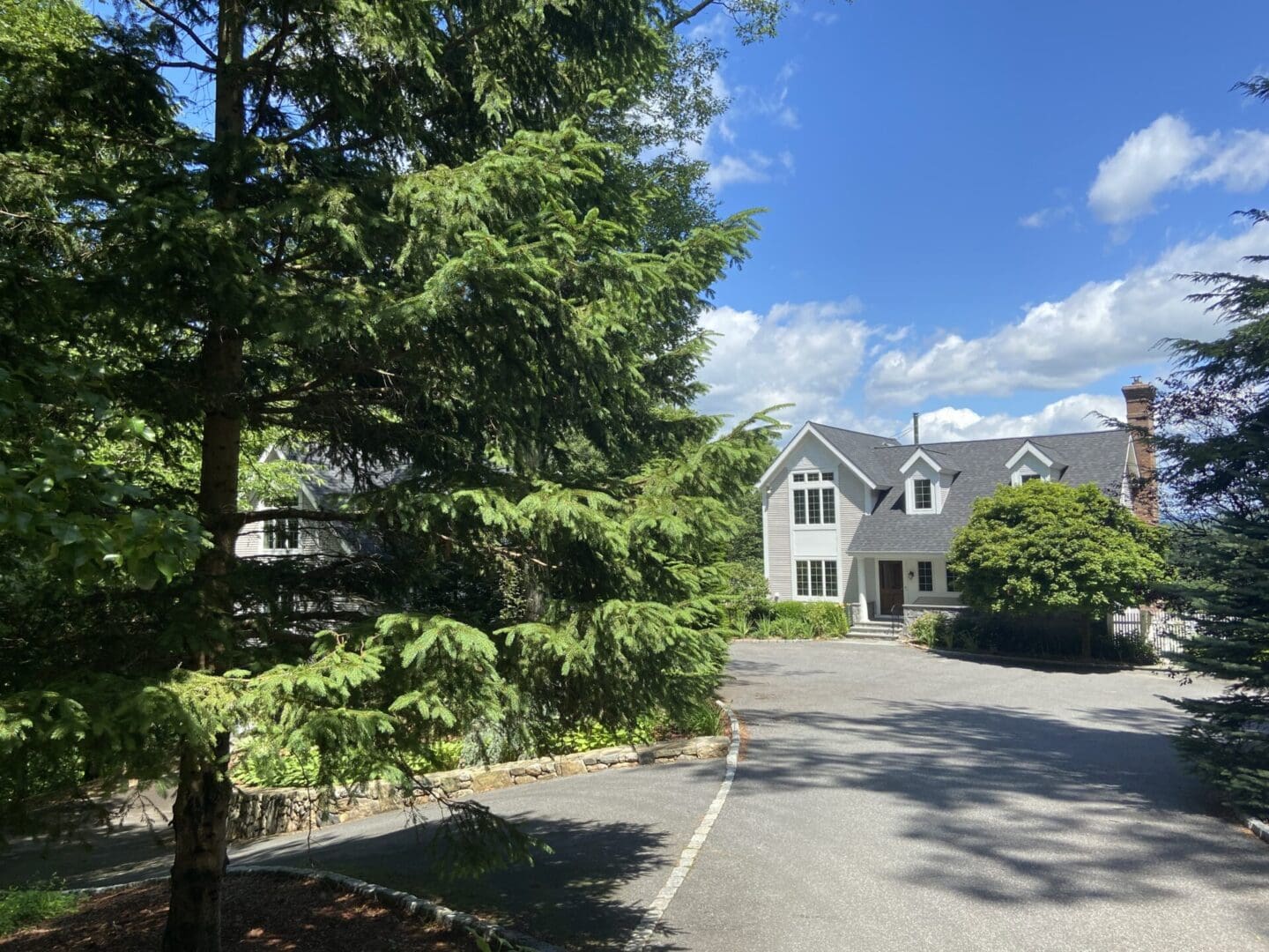 Large house driveway, sunny day.