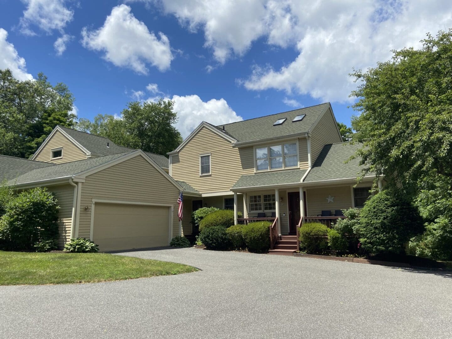 Beige townhouse with attached garage.