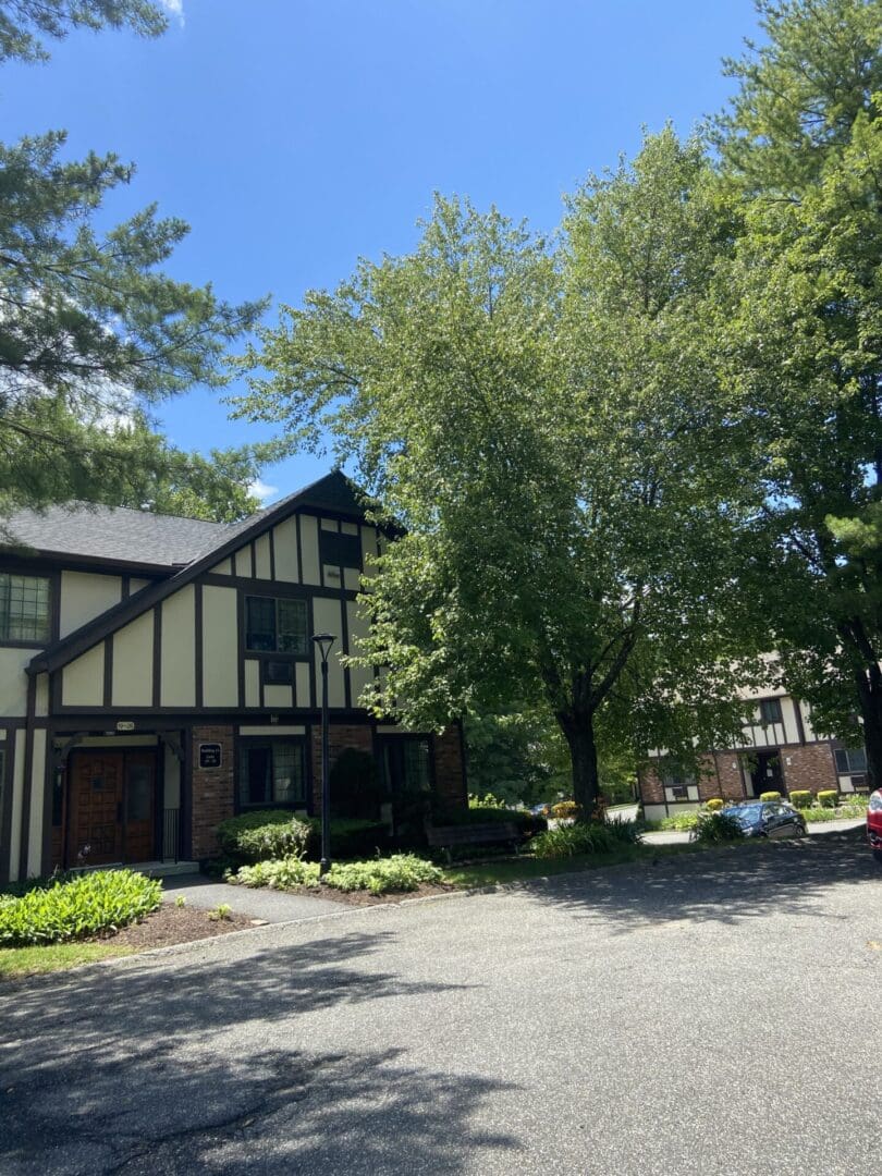 Tudor-style condo building, sunny day.