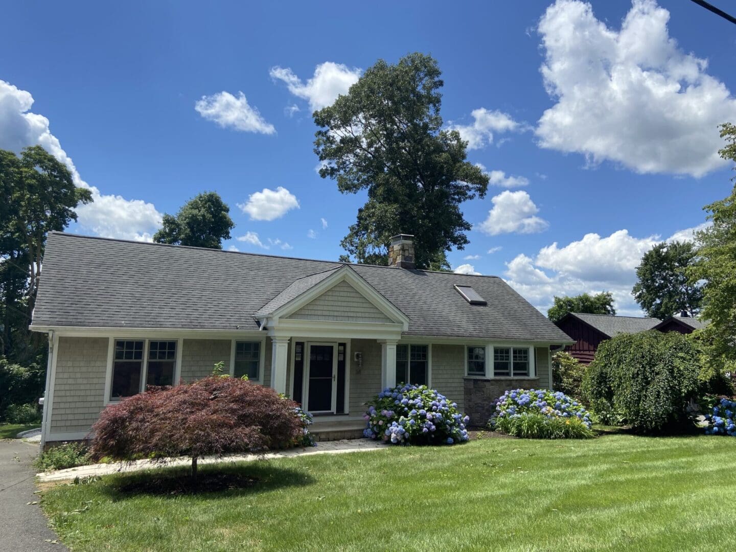 One-story suburban home with green lawn.