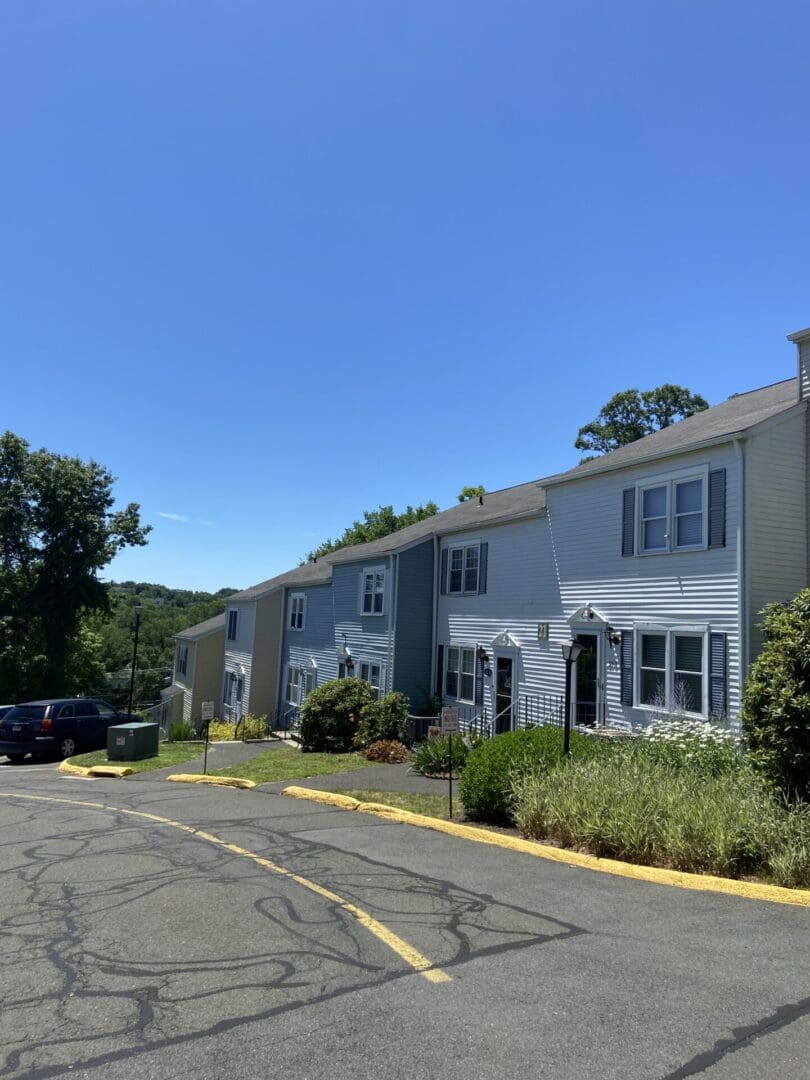 Row of townhouses with blue sky.