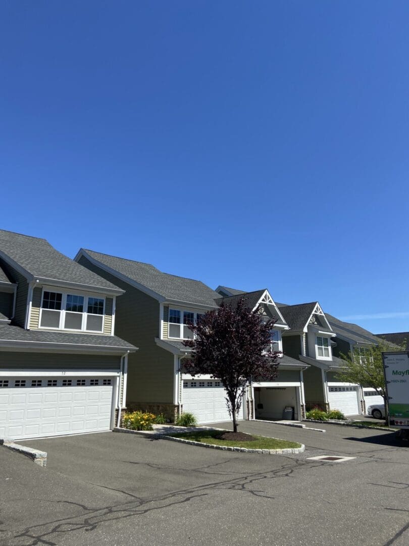 Townhouses with attached garages on sunny day.